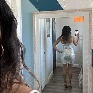 A cute mini dress perfect for any occasion. Embellished with silver sequence.